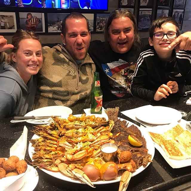 Locals enjoying a seafood platter A group of four Galveston locals enjoy a B.O.I Seafood platter.